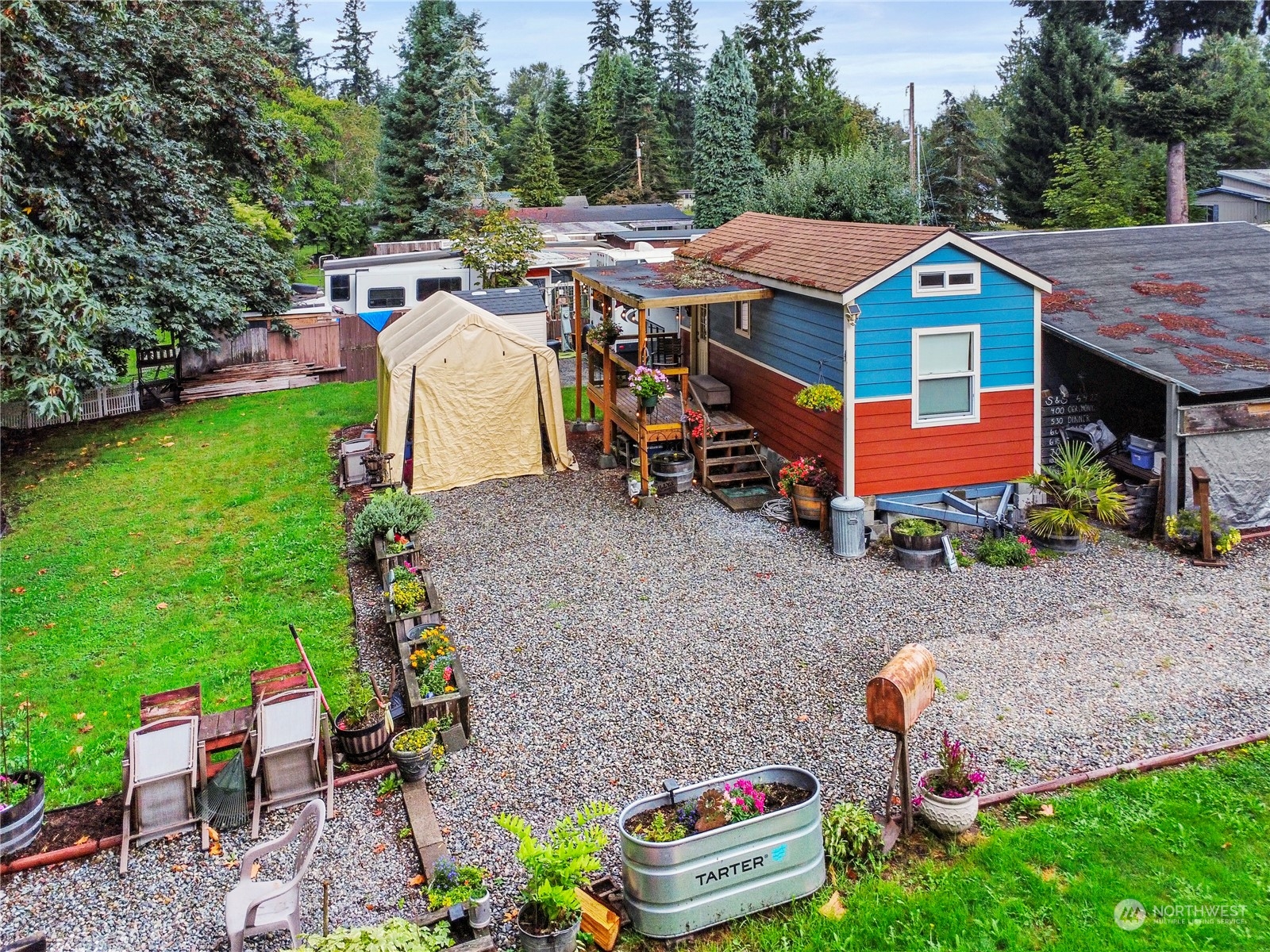 a view of a house with a yard and lawn chairs