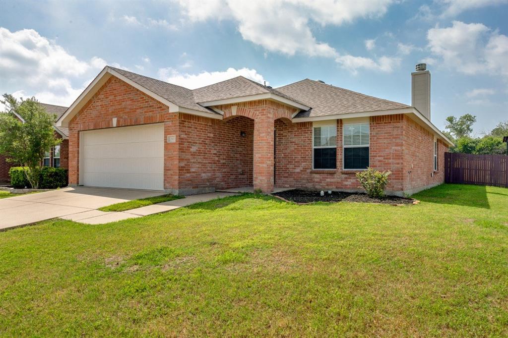 a front view of house with yard and garage