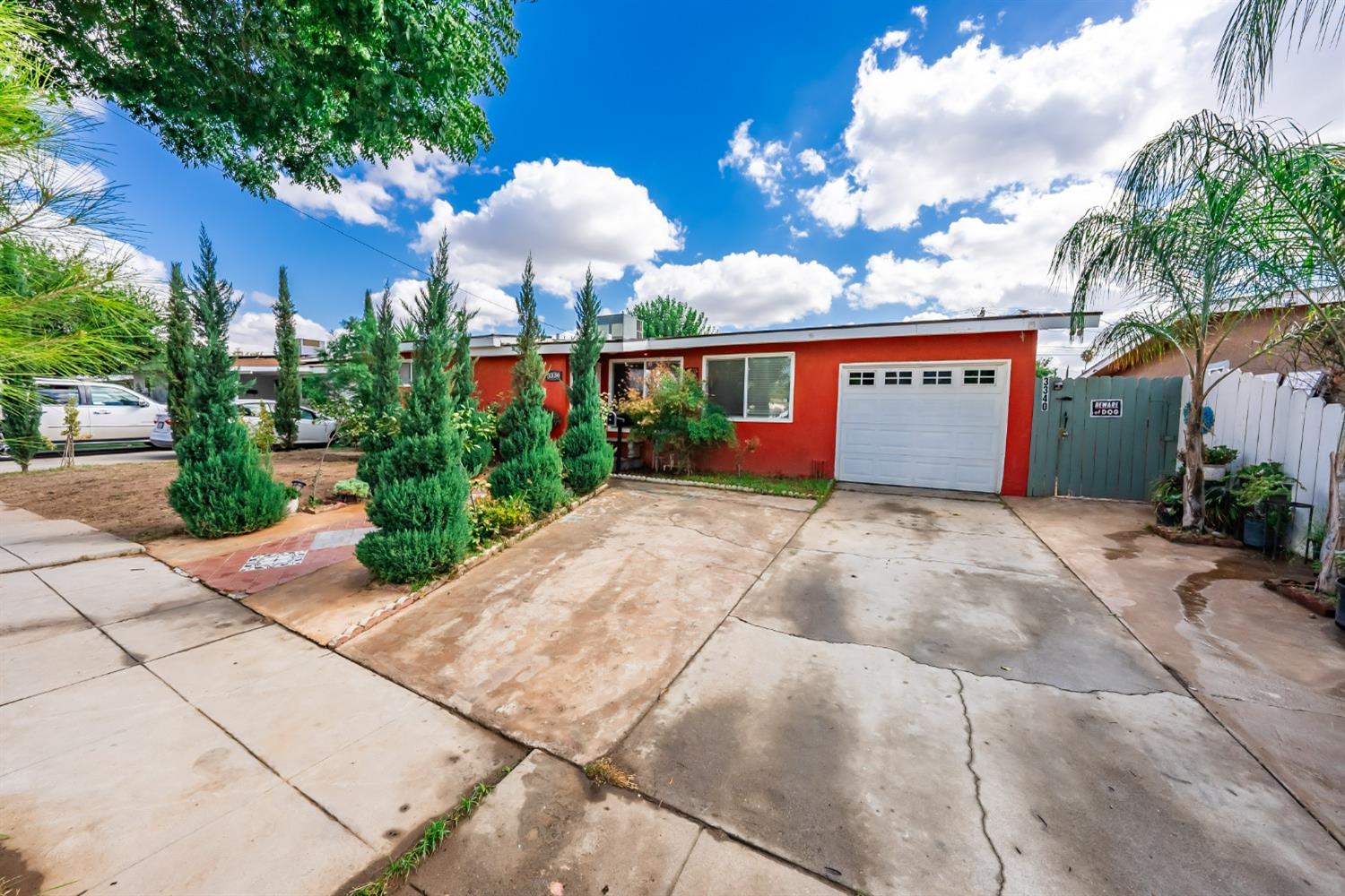 a view of a house with a yard and potted plants