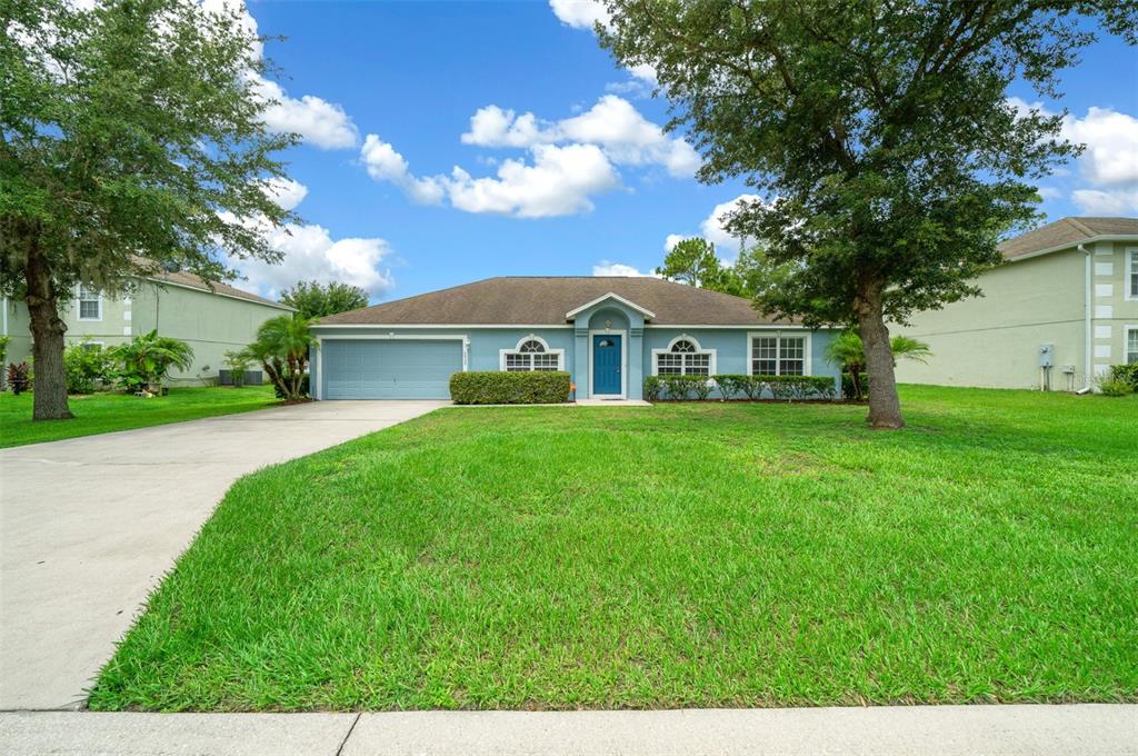 a view of house that has a yard