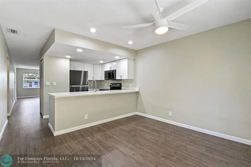 a view of kitchen with wooden floor