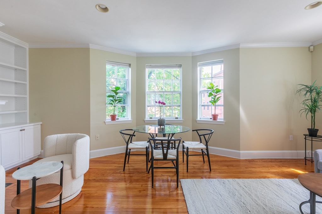 a dining room with wooden floor and a table