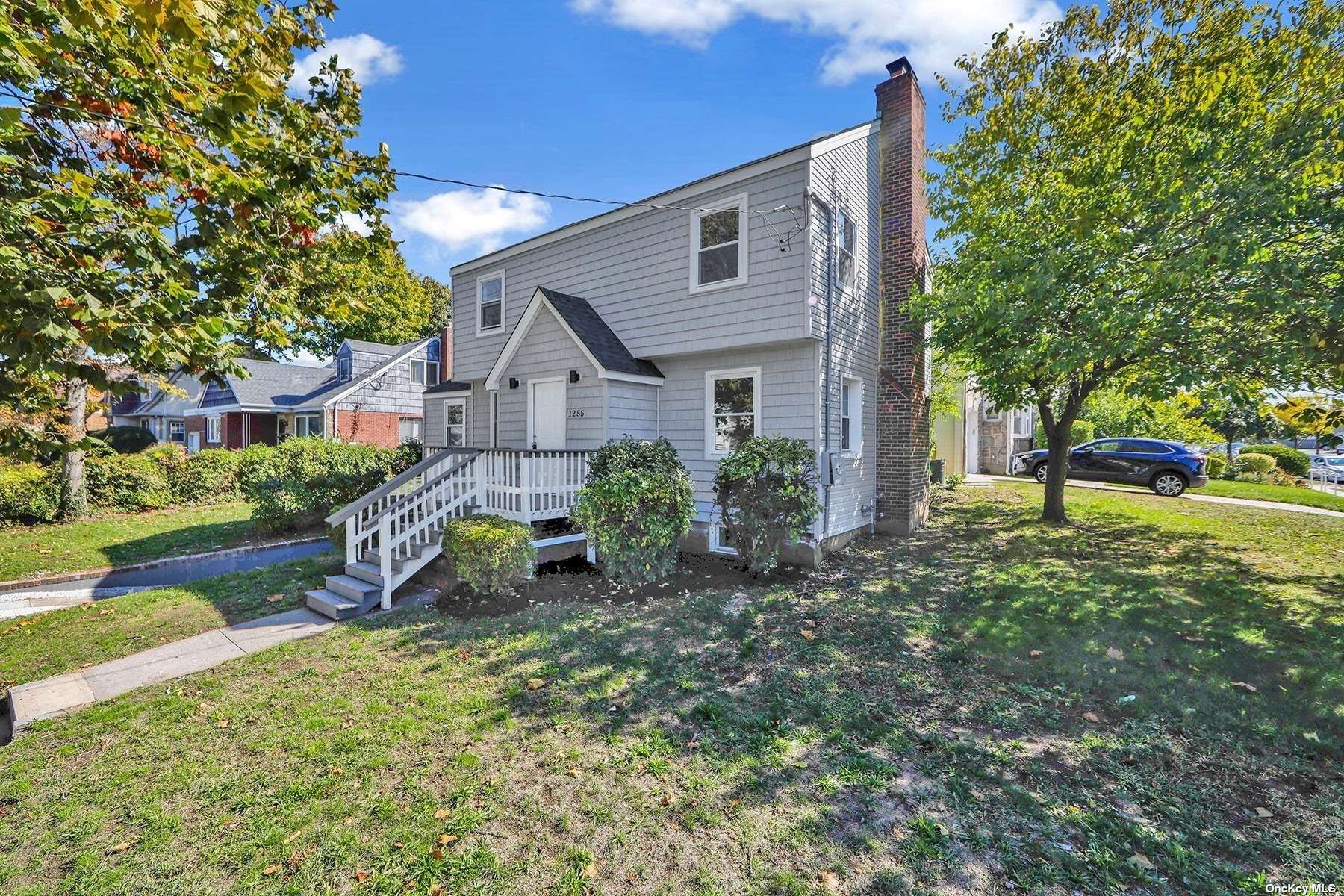 a view of a house with a yard and tree s