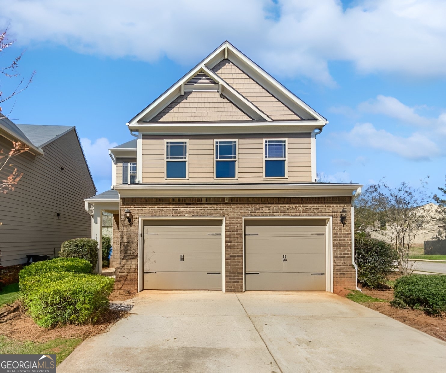 a front view of a house with a garage