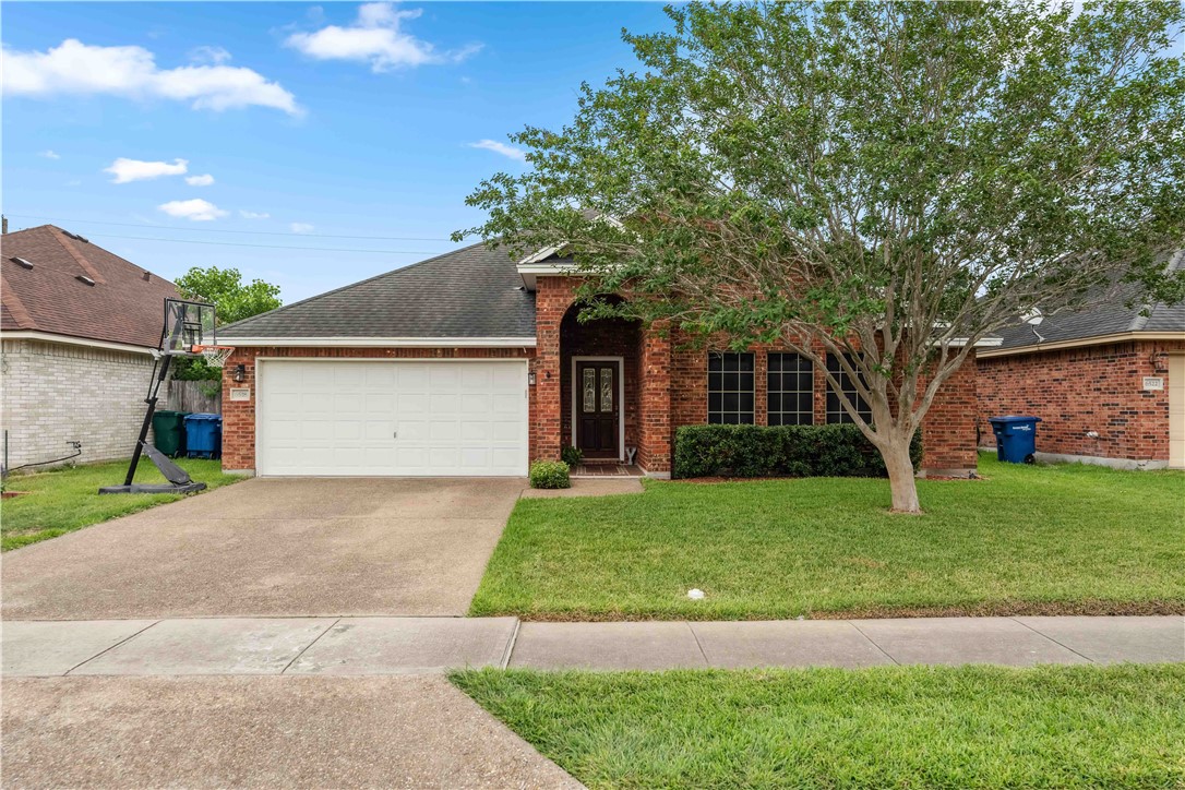 a front view of a house with a yard and garage