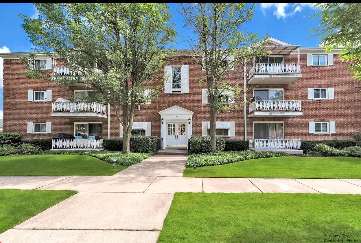 a front view of building with yard