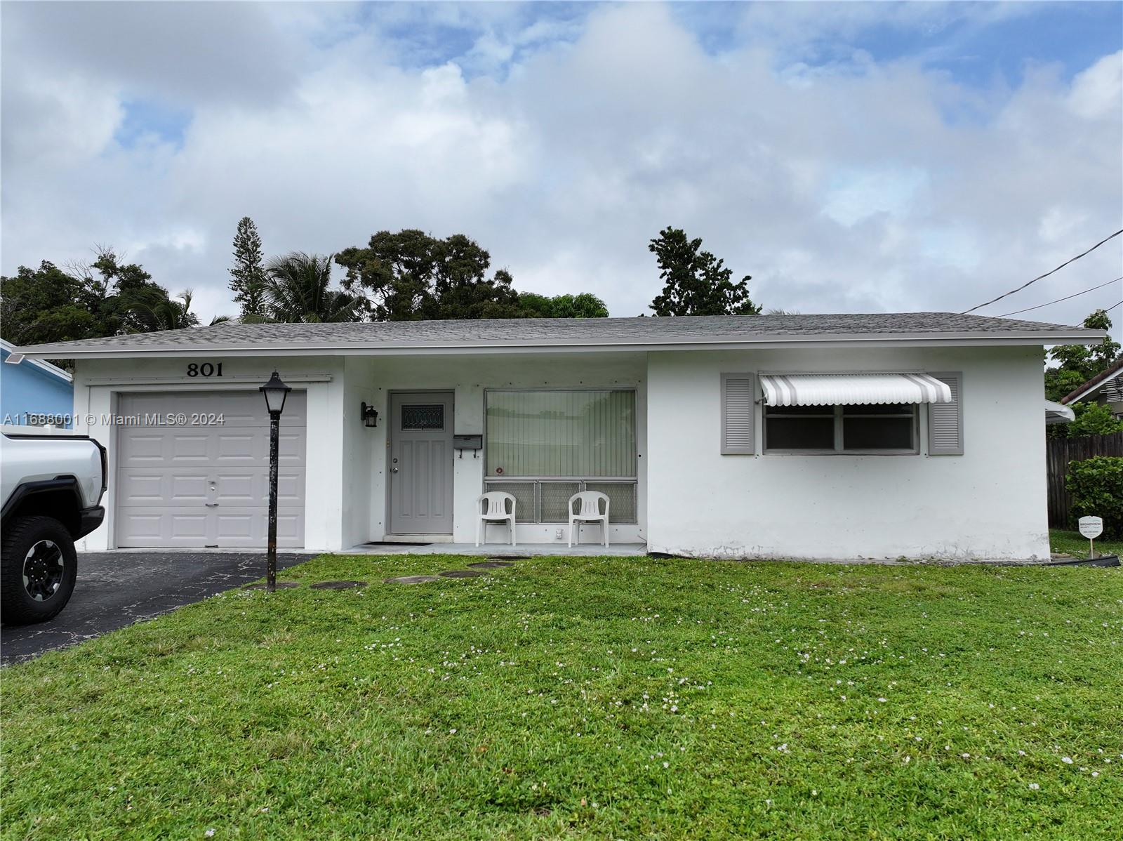 a front view of a house with a garden and plants