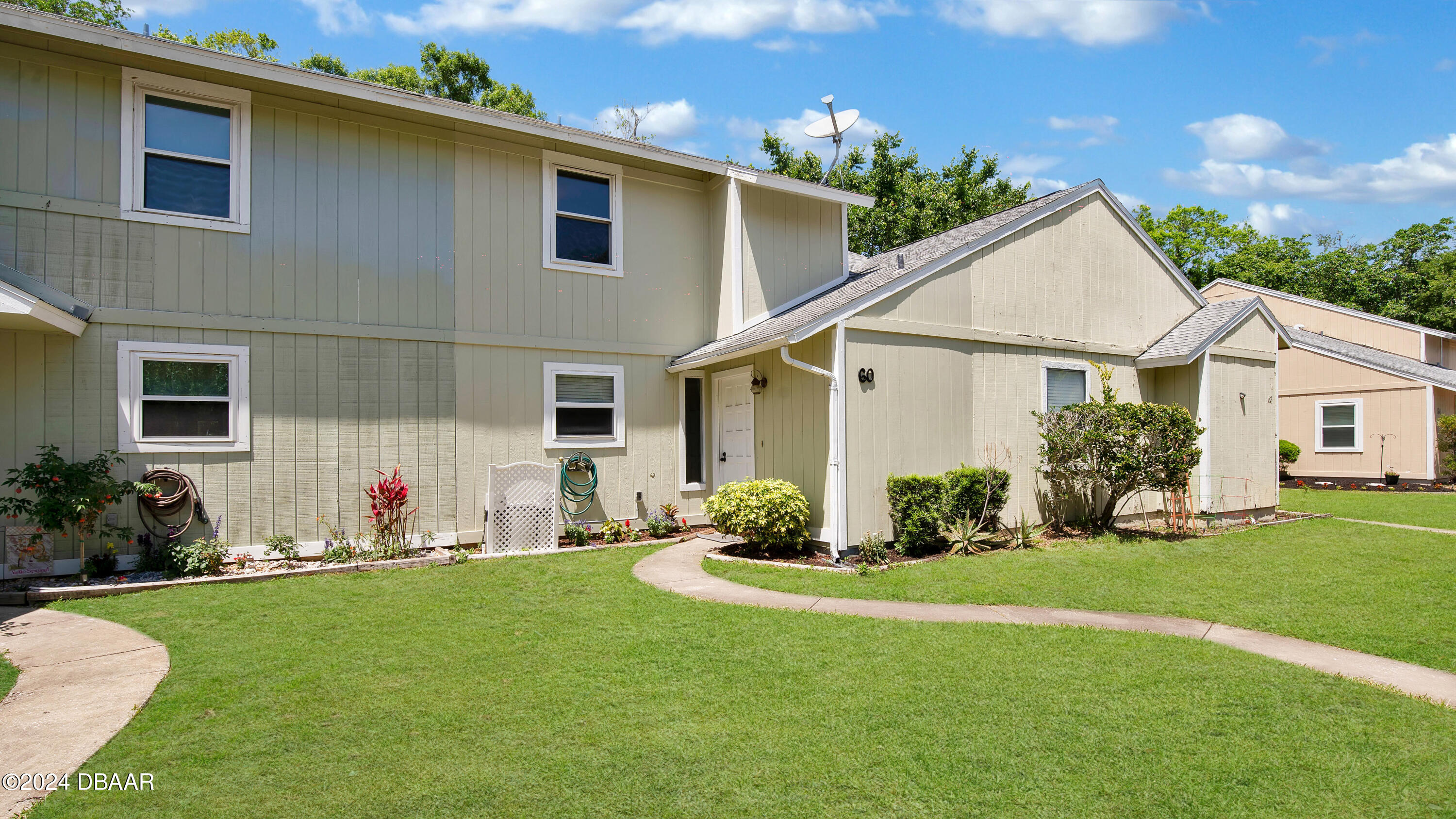 a front view of house with yard and green space