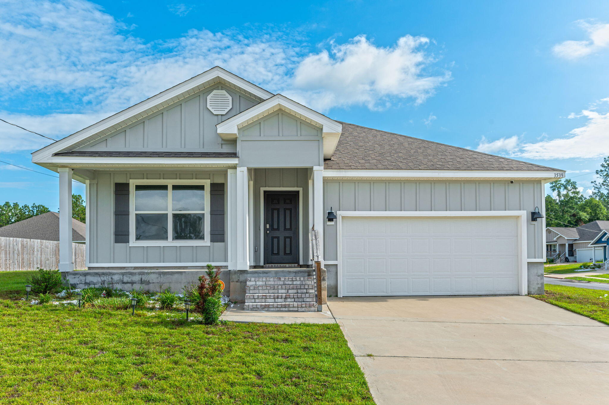 a front view of a house with a yard and garage