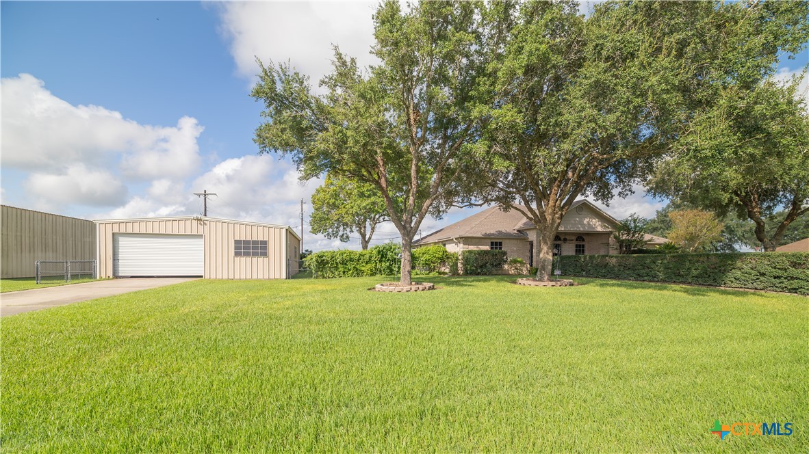 a front view of house with yard and trees