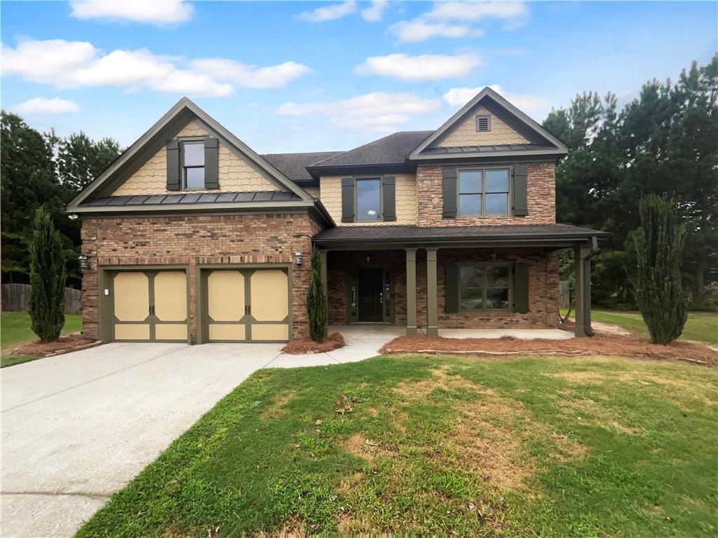 a front view of a house with a yard and garage