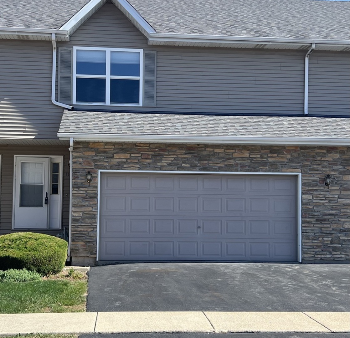 a view of a brick house with a garage