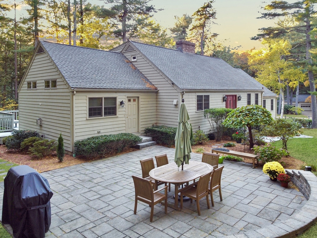 a backyard of a house with yard fire pit and furniture