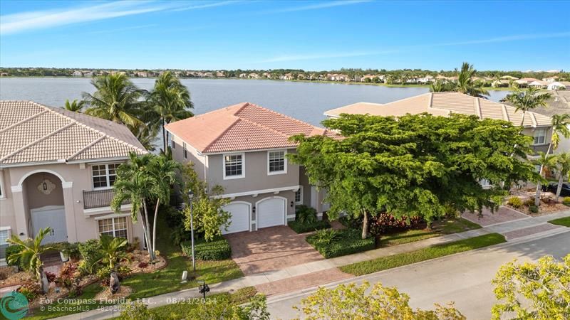 an aerial view of a house with outdoor space and lake view