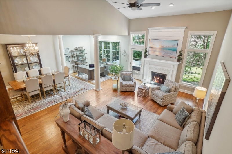 a living room with furniture large window and a fireplace