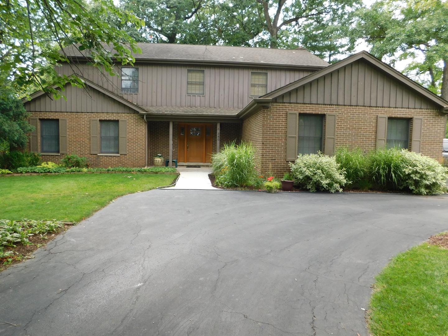 a front view of a house with a garden and plants