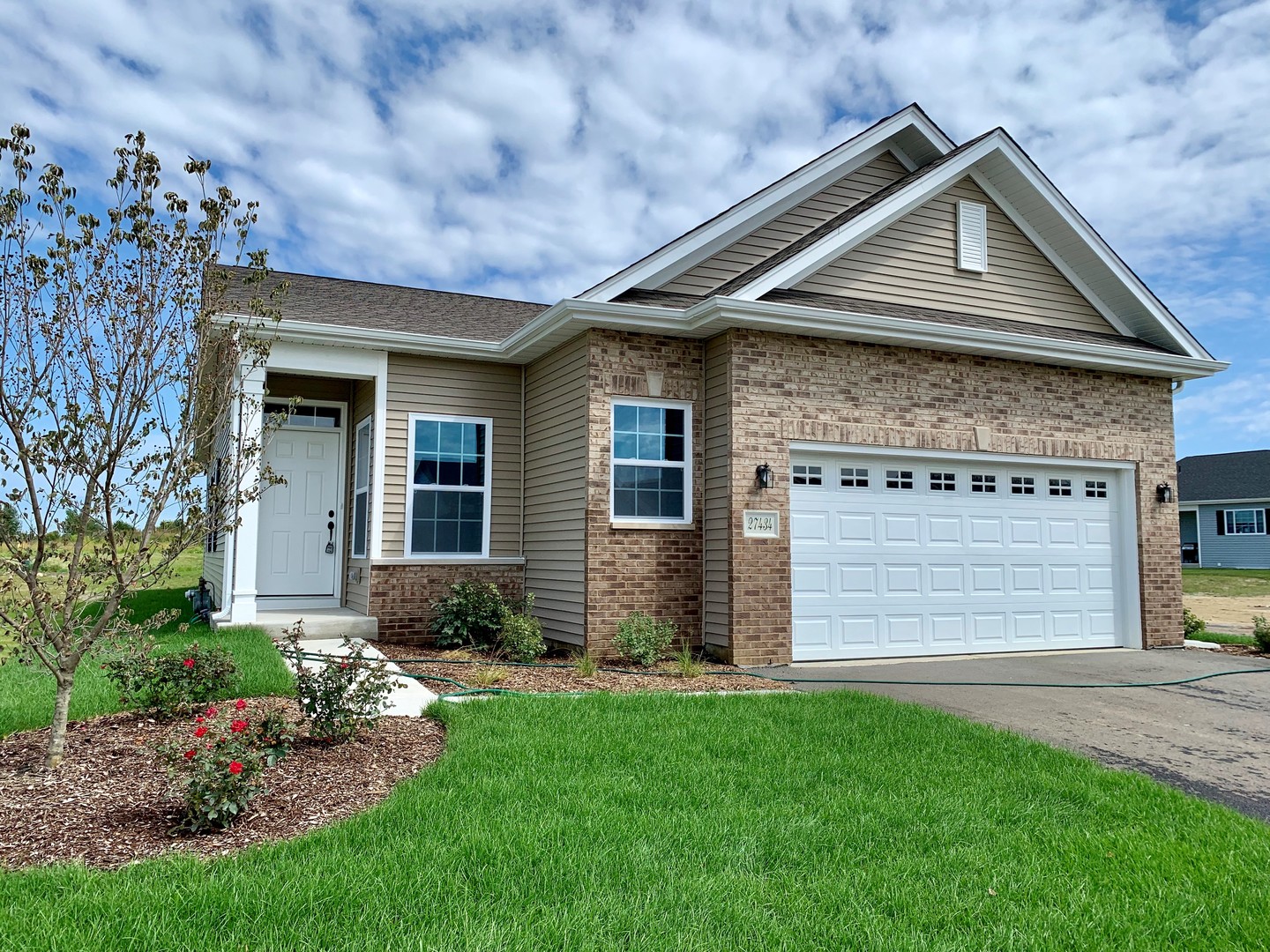 a front view of a house with a garden