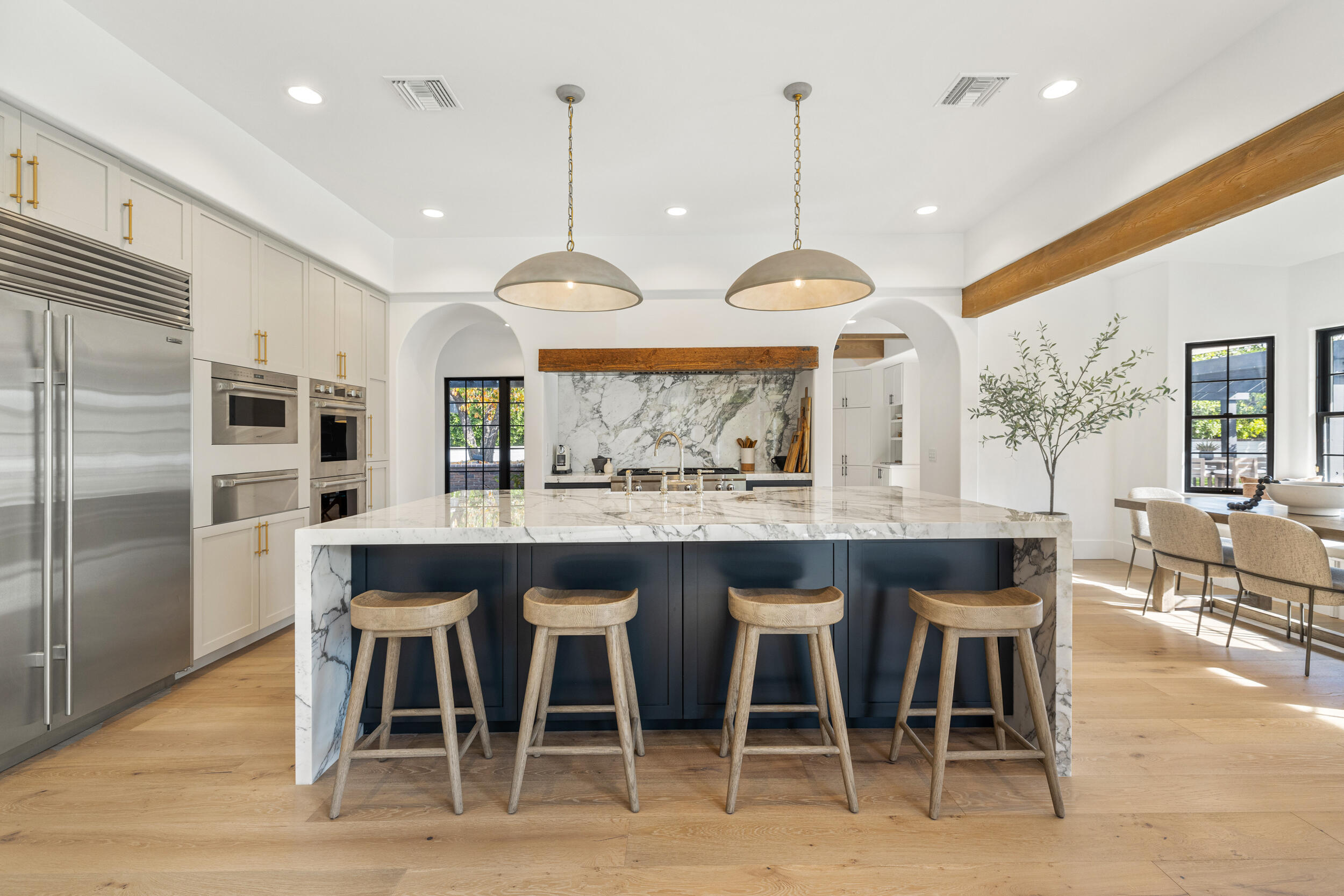 a large kitchen with a table and chairs