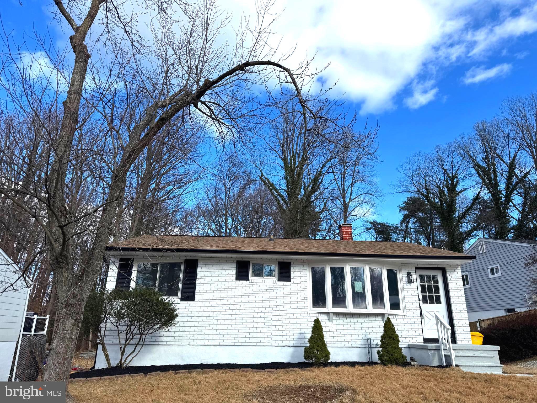 a view of house with a trees in the background