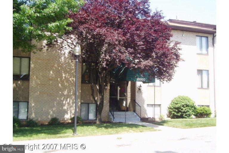 a view of a house with a tree in the background