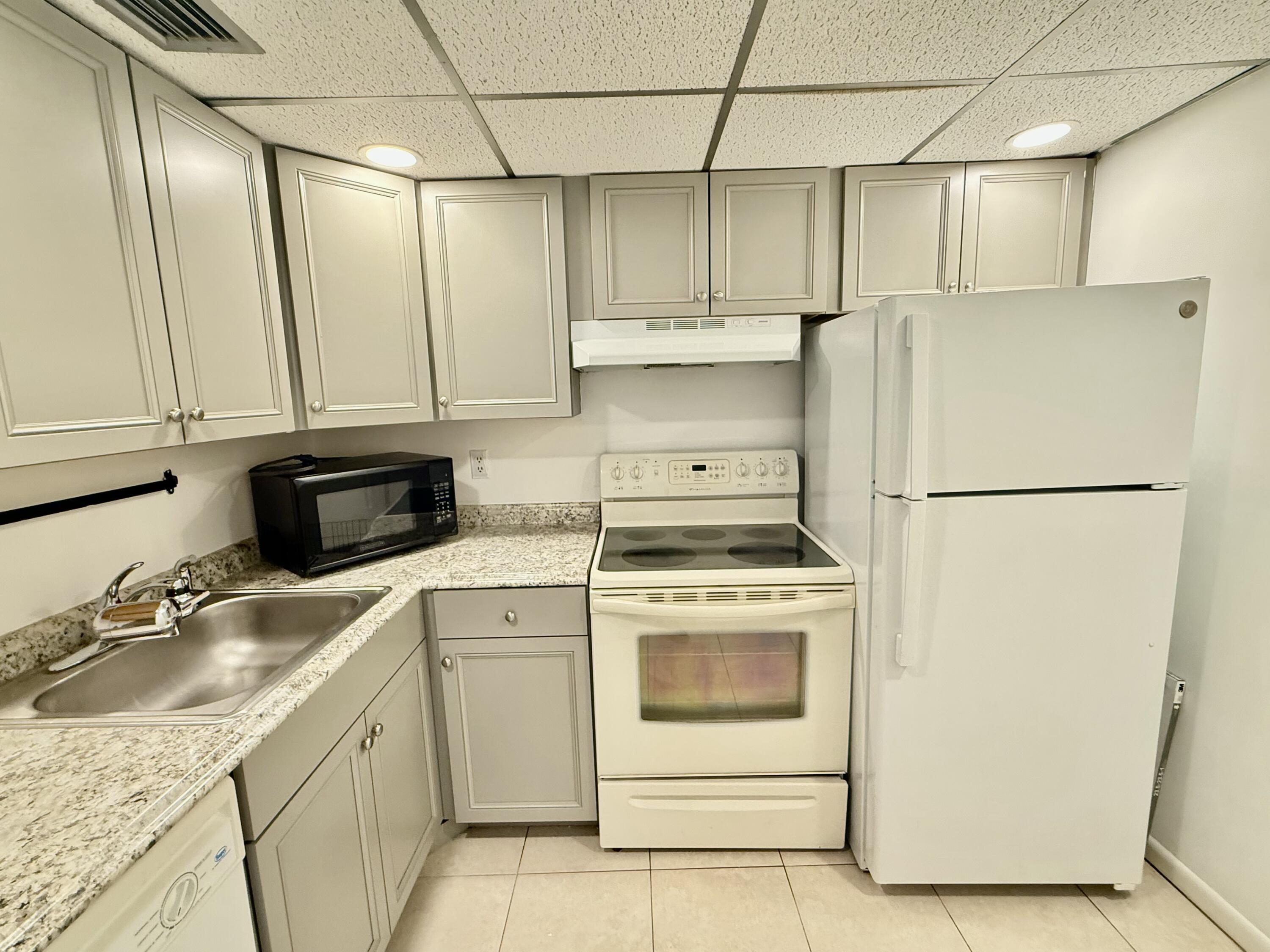 a kitchen with a stove a refrigerator and a sink