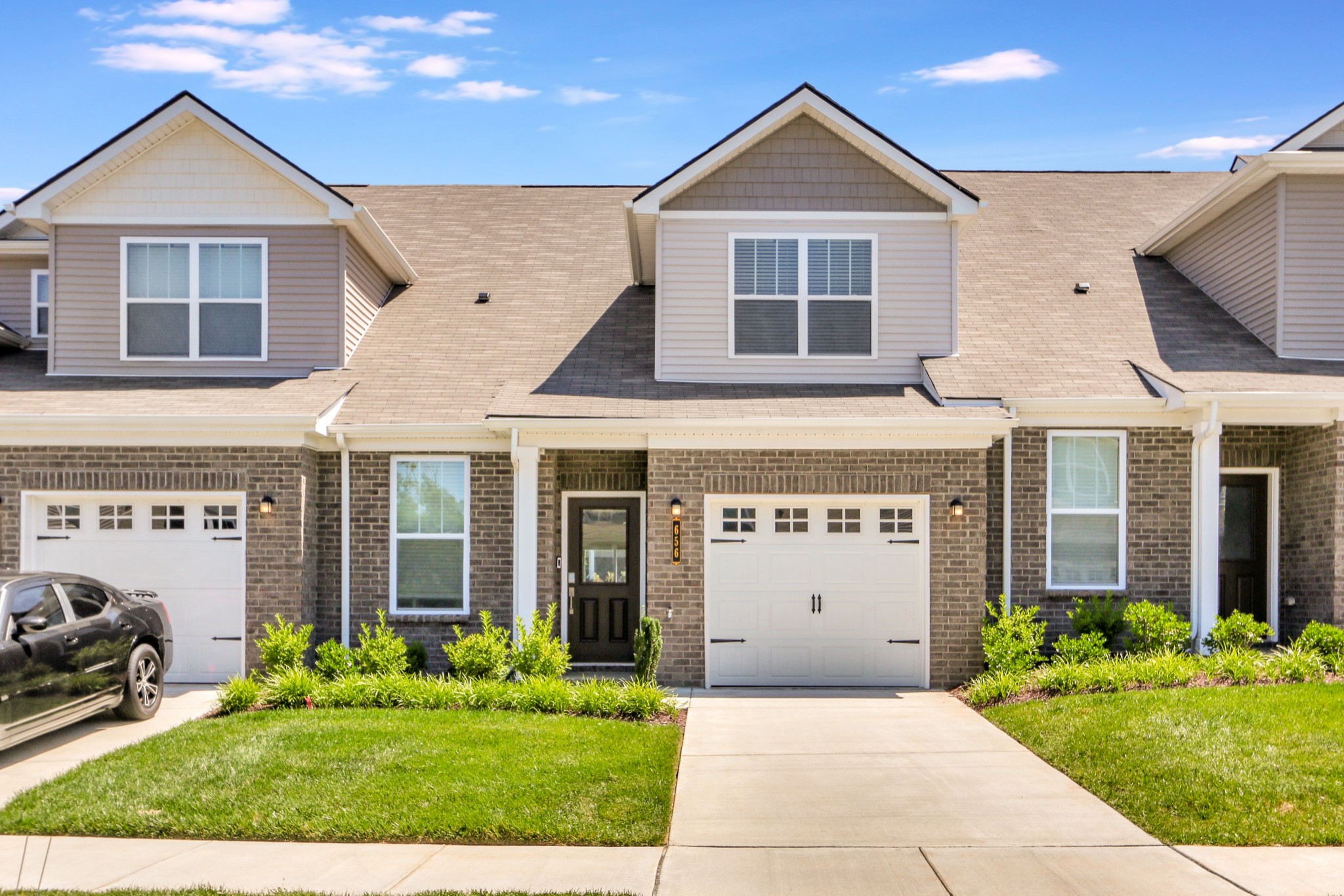 a front view of a house with a yard and garage