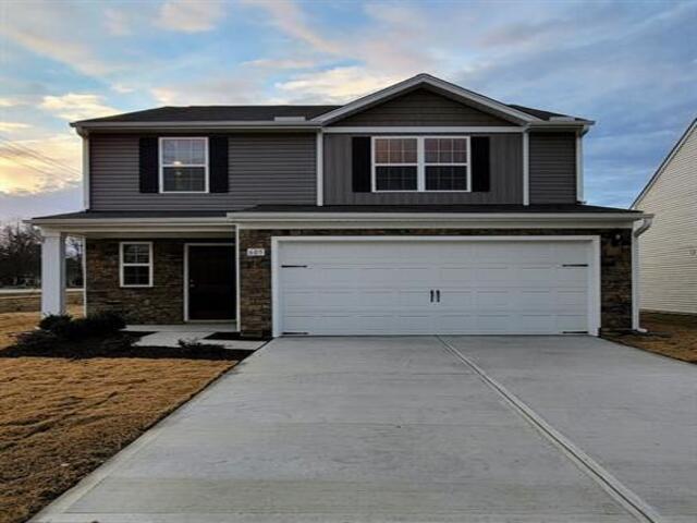 a front view of a house with parking space