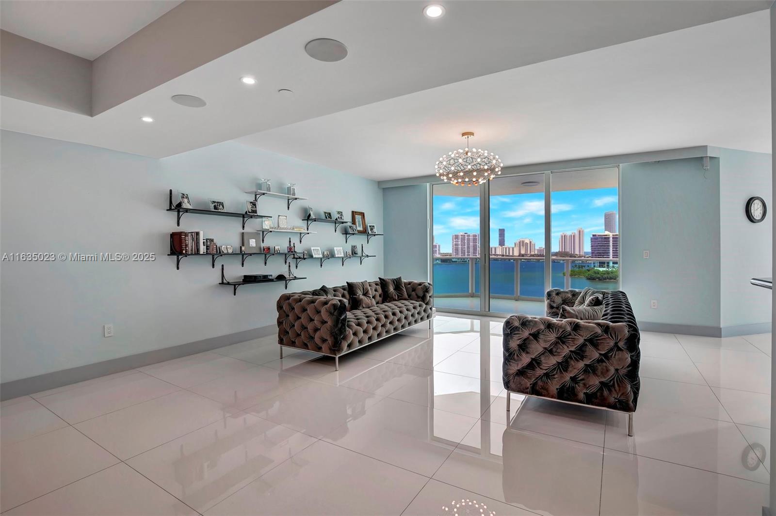 a living room with furniture and a chandelier