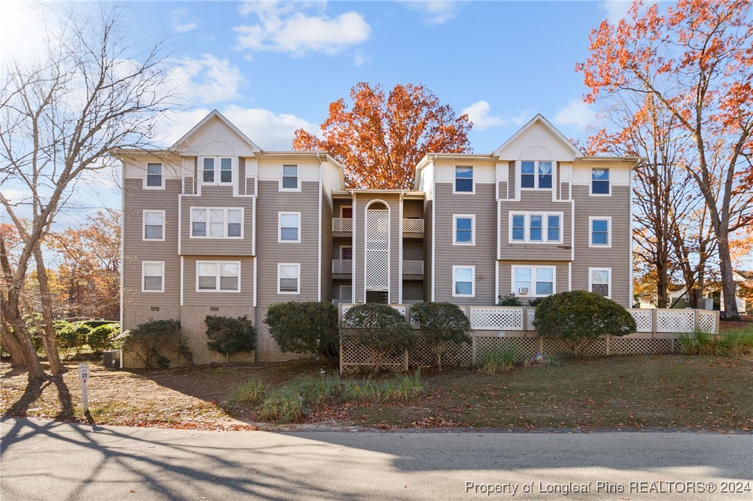 a front view of a residential apartment building with a yard