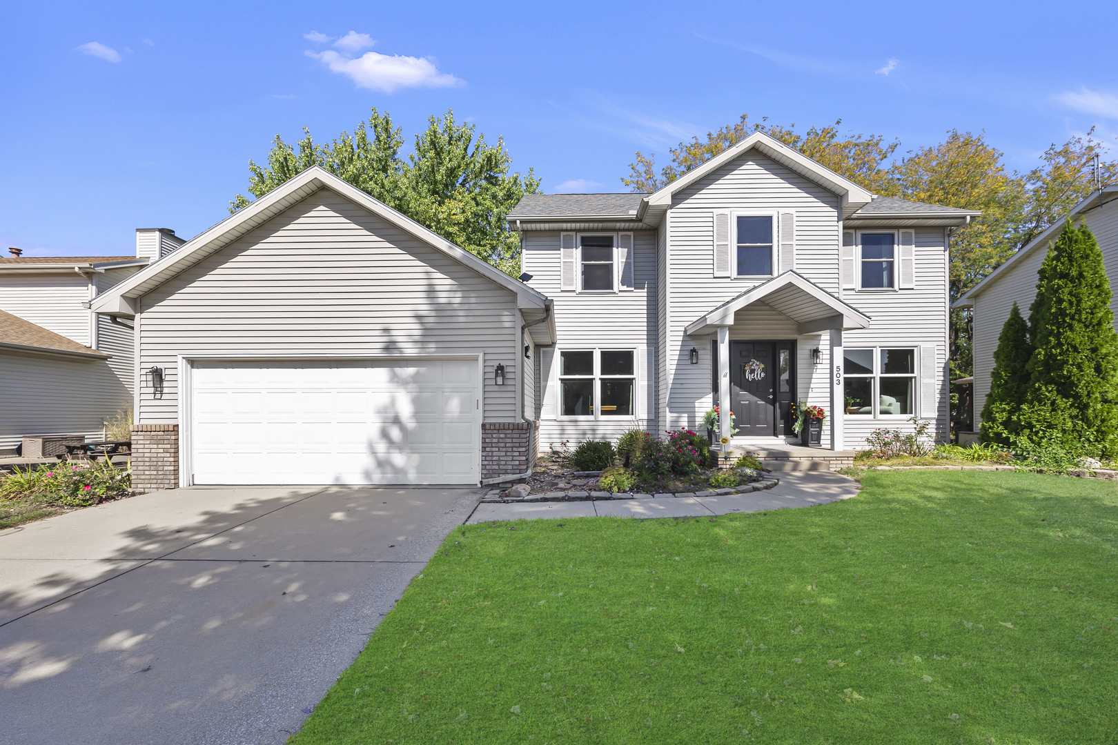 a front view of a house with a yard and garage