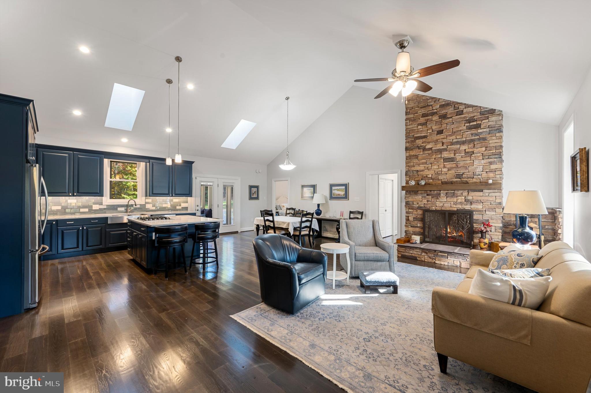 a living room with furniture kitchen view and a fireplace