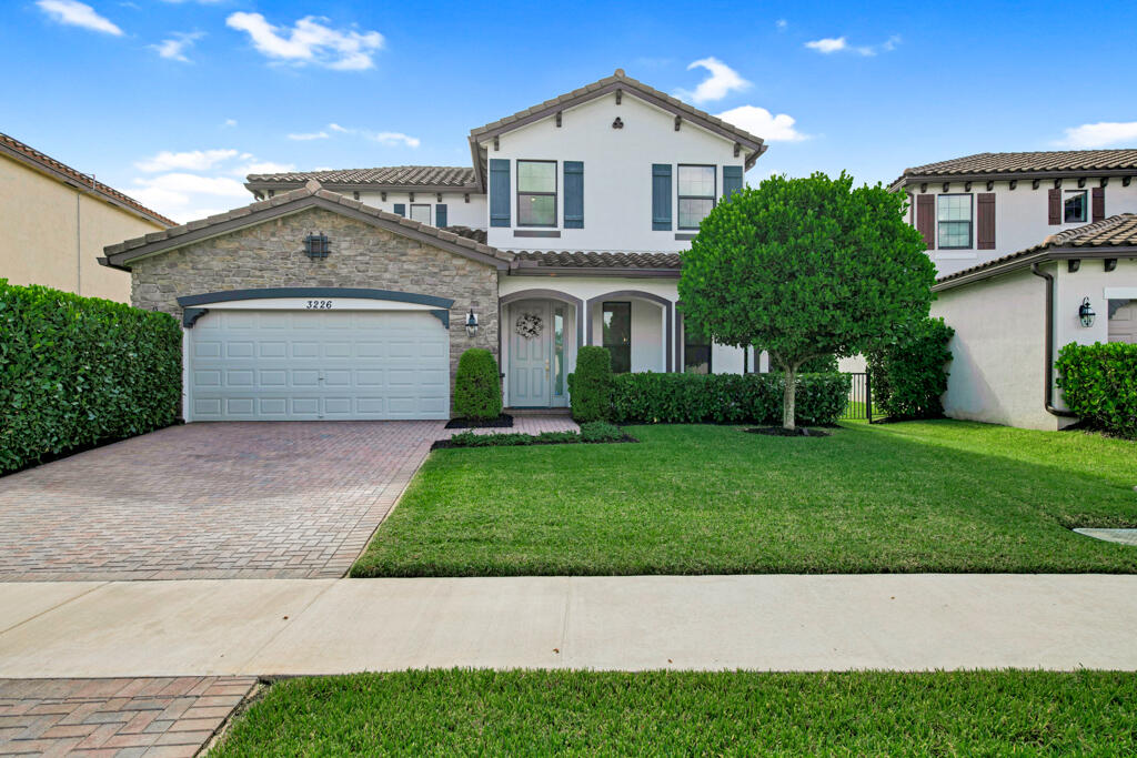 a front view of a house with a yard and garage