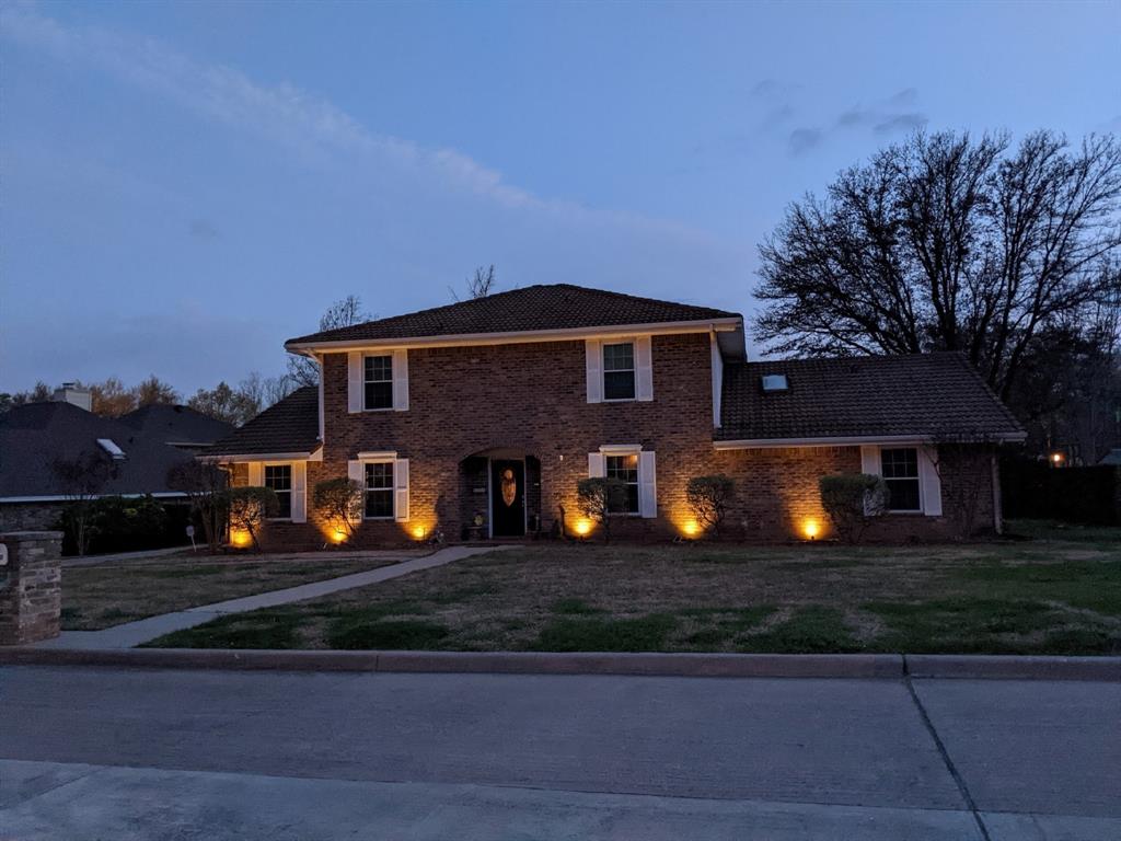 a front view of a house with lots of trees