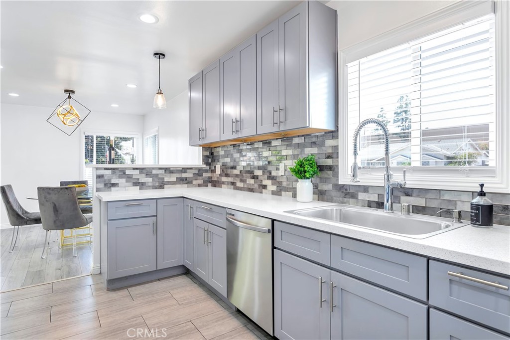 a kitchen with a sink cabinets and window