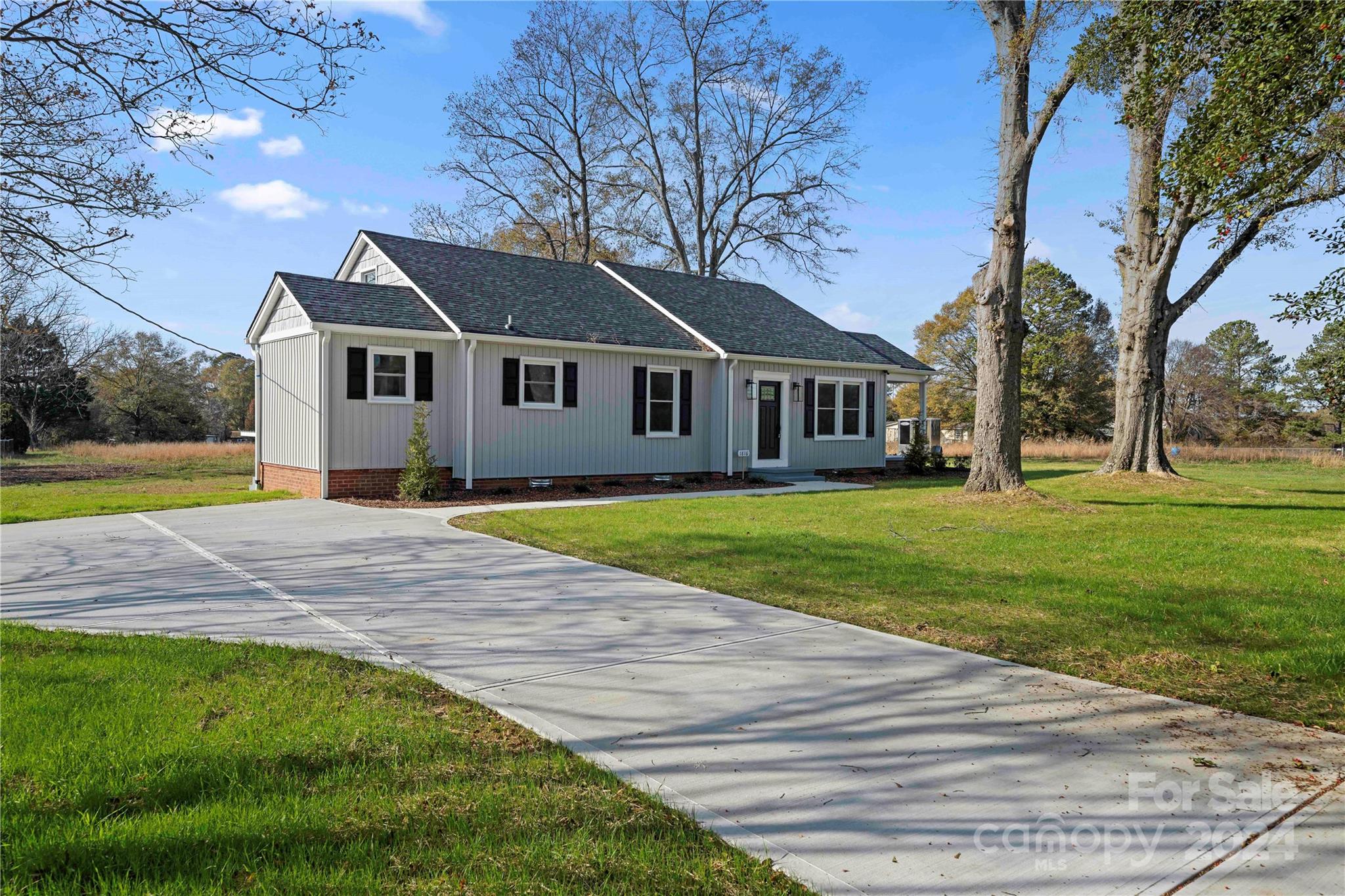 a front view of house with yard and green space