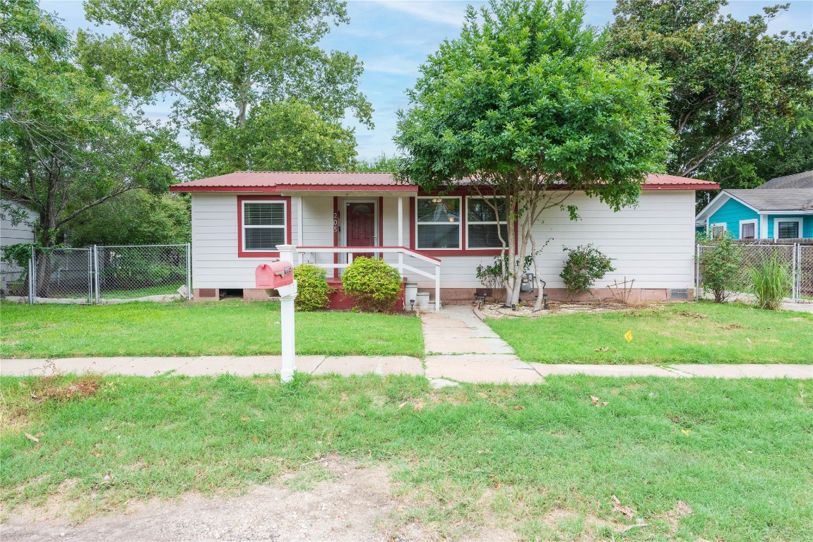 a view of a house with a yard and a garden