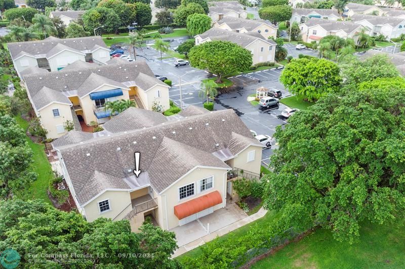 an aerial view of a house with a garden and swimming pool