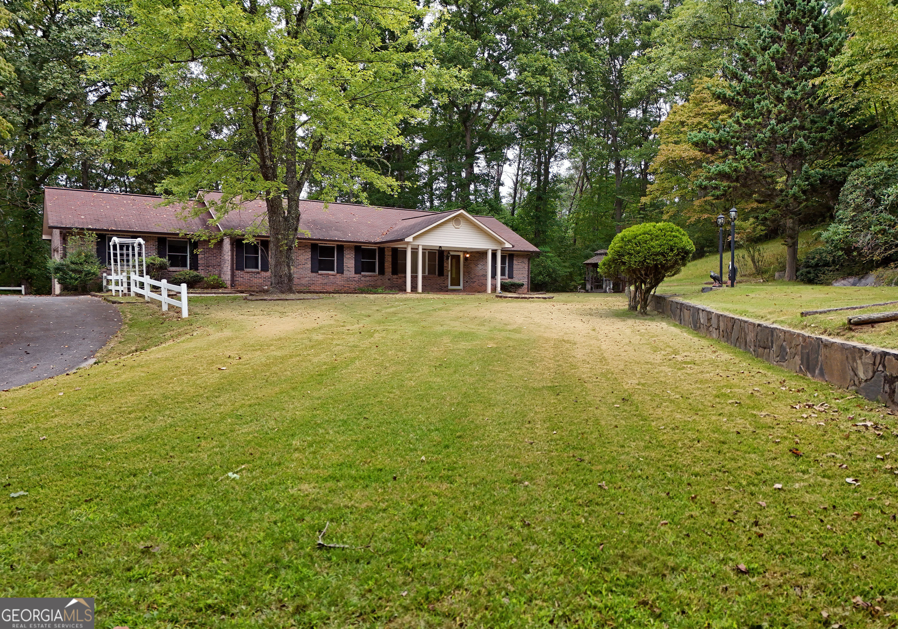 a front view of a house with yard and green space