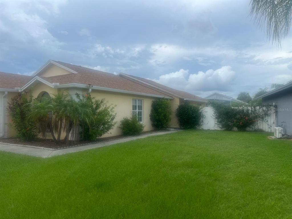 a view of a house with a backyard