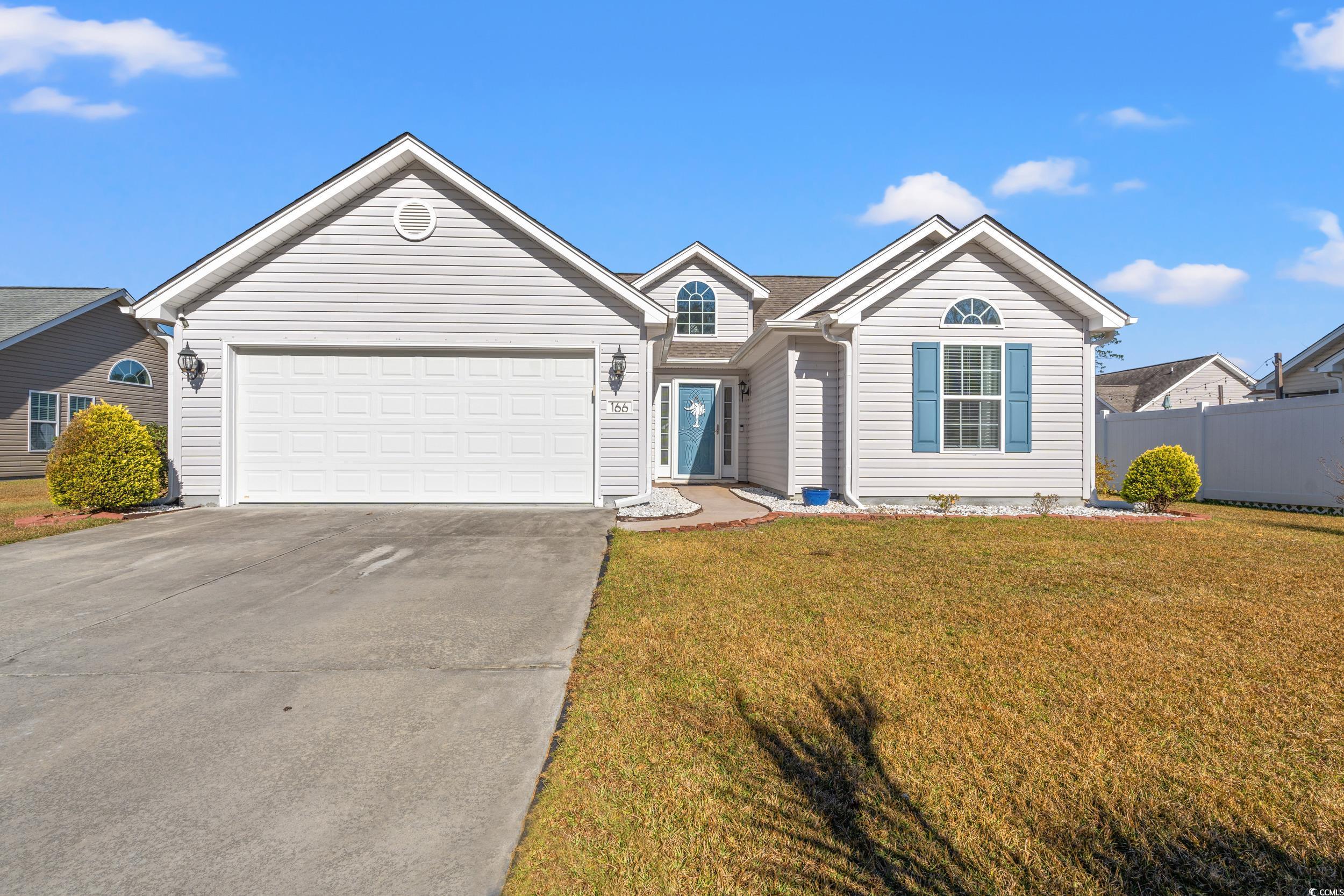 Ranch-style house with a front yard and a garage