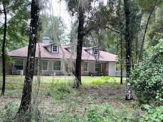 a house with lots of trees in the background