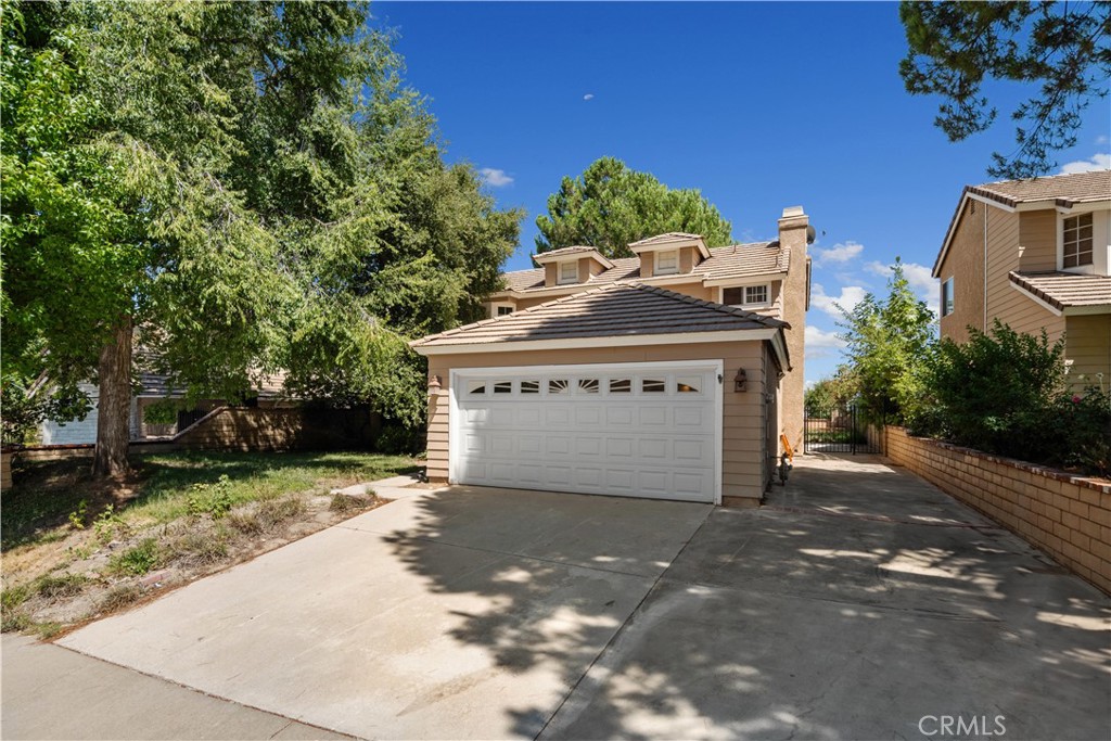 a view of a house with a yard and a garage