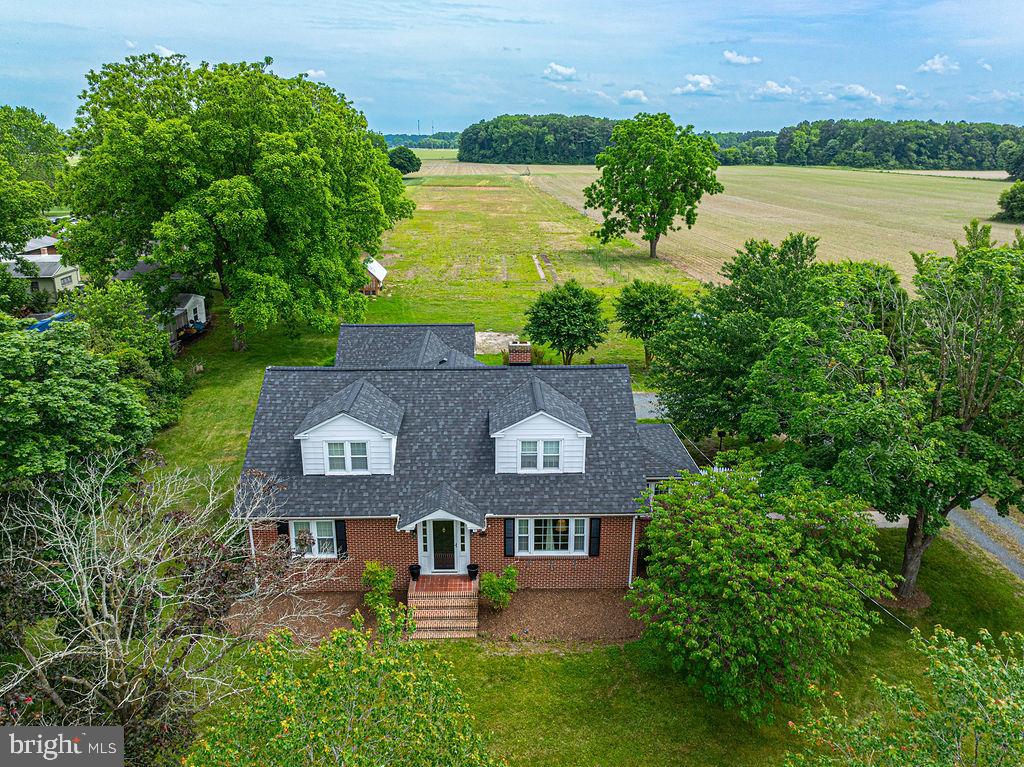 an aerial view of a house with outdoor space and lake view