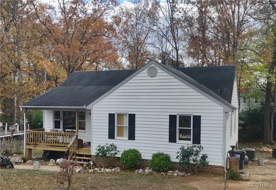 a view of a house with a yard and large trees