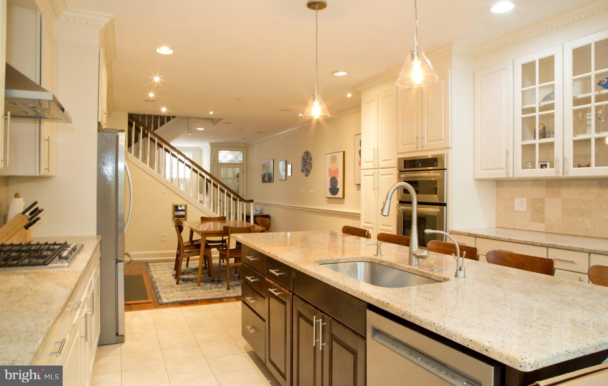 a kitchen with counter top space a sink appliances and cabinets