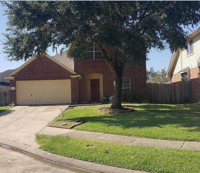 a house that has a tree in front of it