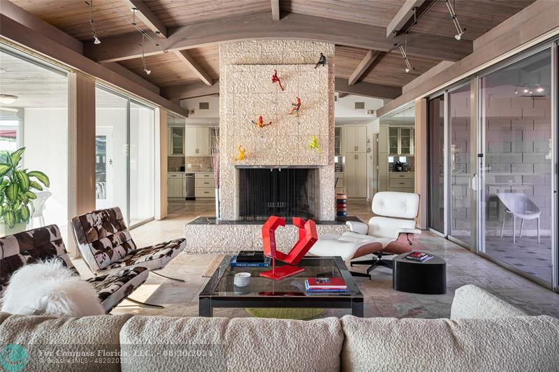 a living room with furniture fireplace and a chandelier