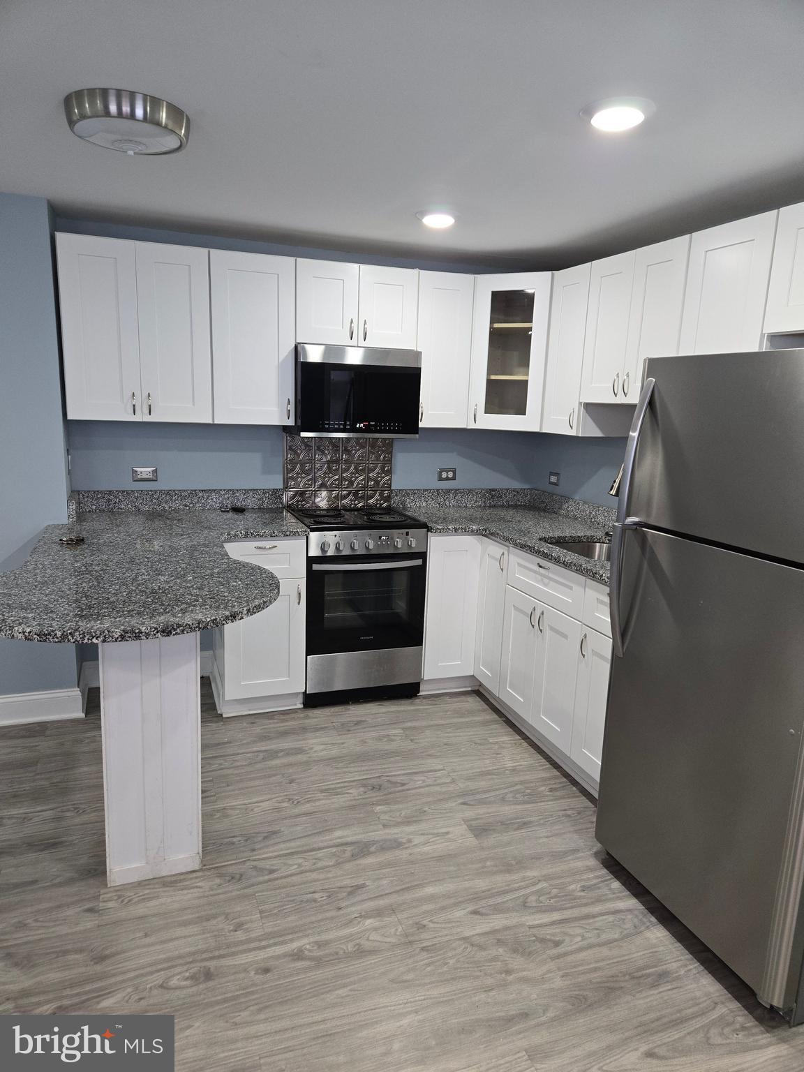 Image of a fully renovated kitchen with cabinetry.