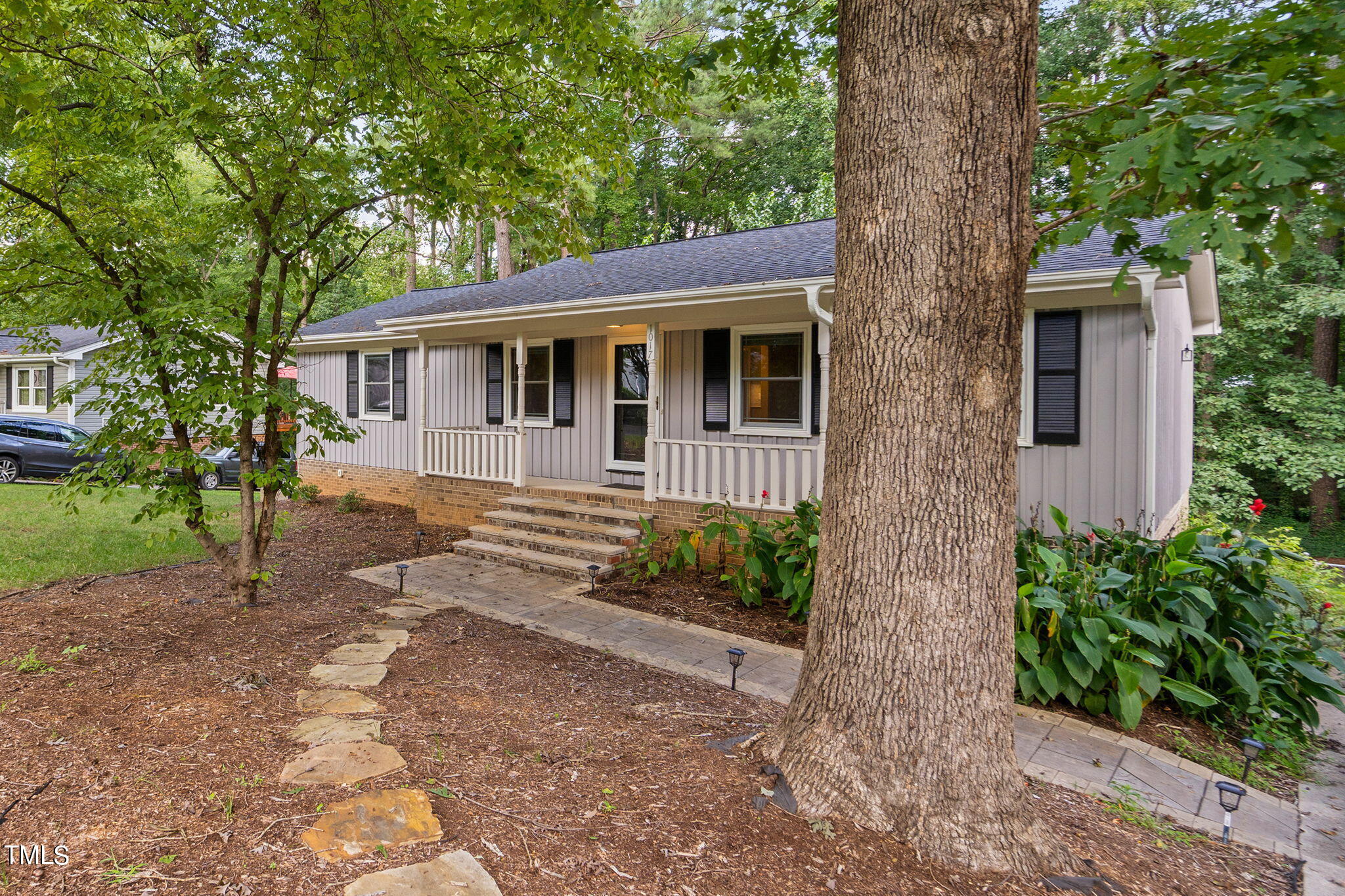 a front view of a house with garden