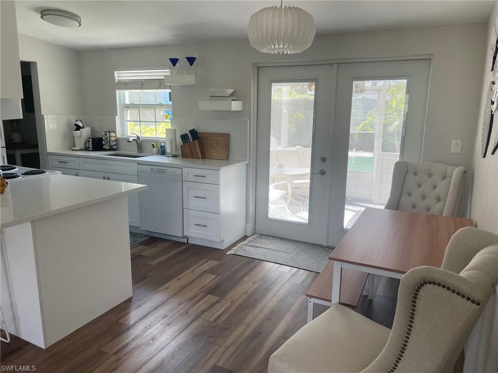 a living room with furniture and two window